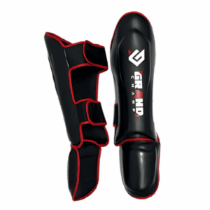 espinilleras para combate marca grand champ color negro con detalles en color rojo y letras blancas